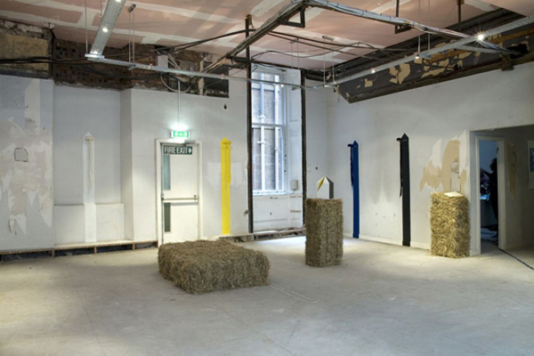 installation titled aromatic monitor by mair hughes made with wool fleece and brass fixtures
